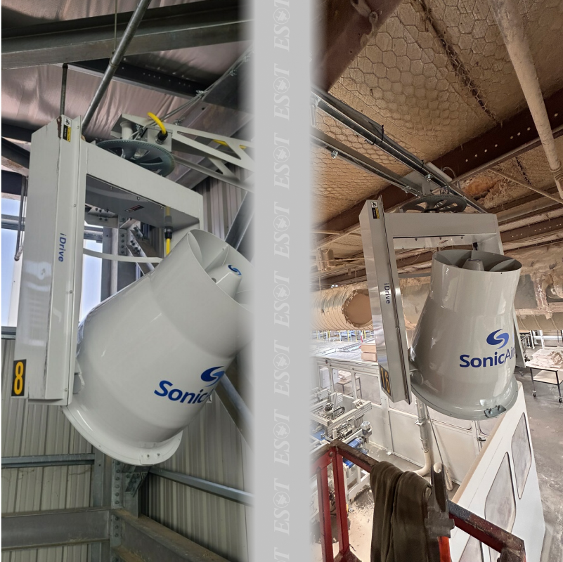 A high-powered industrial fan mounted on the ceiling, effectively controlling dust and debris in a warehouse setting.