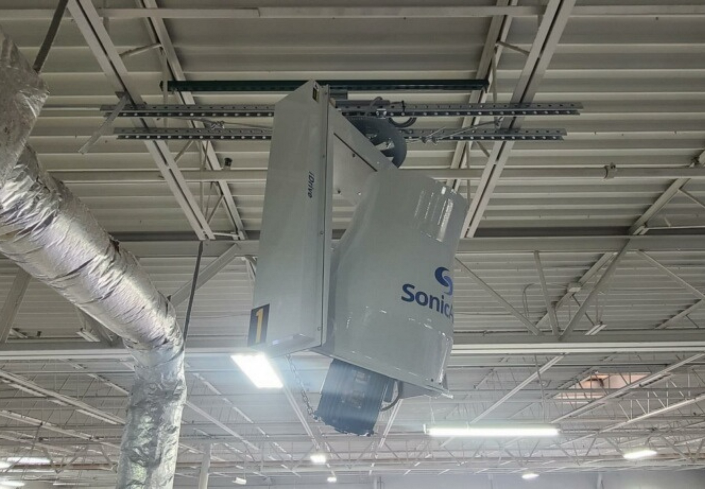  A powerful industrial ceiling fan with multiple blades efficiently moving air in a warehouse environment, reducing dust and improving air quality.