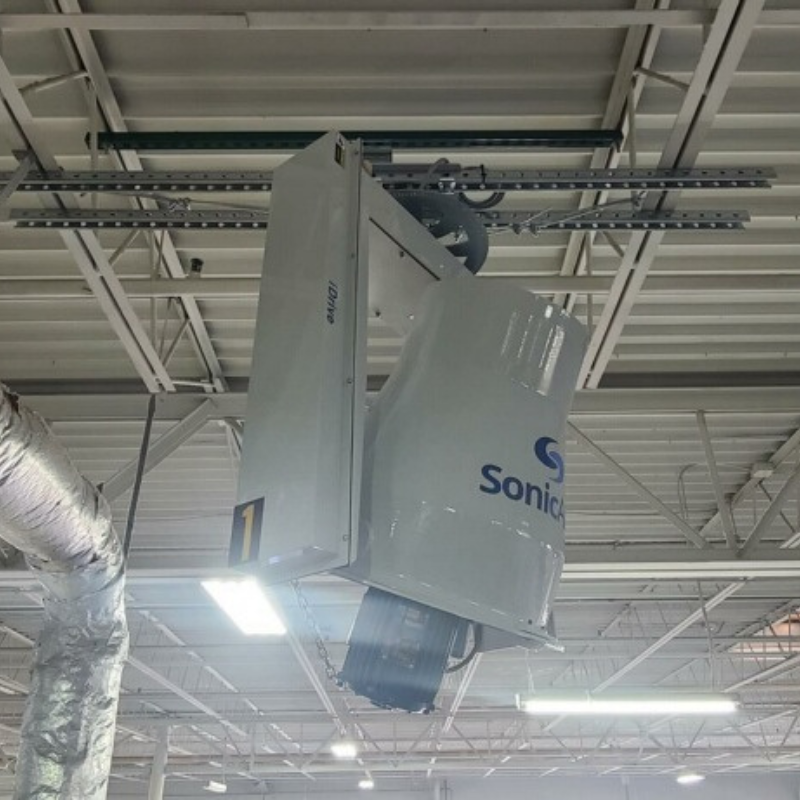  A powerful industrial ceiling fan with multiple blades efficiently moving air in a warehouse environment, reducing dust and improving air quality.